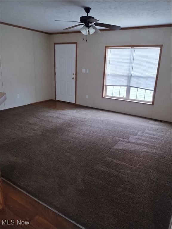 empty room featuring ornamental molding, a textured ceiling, wood-type flooring, and ceiling fan