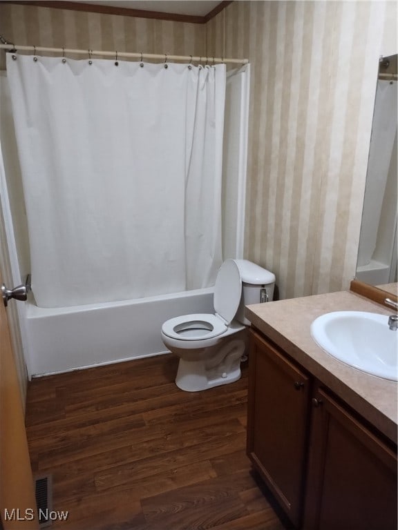 full bathroom with vanity, toilet, hardwood / wood-style floors, and shower / bath combination with curtain