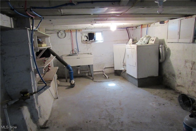 basement with washing machine and dryer and sink