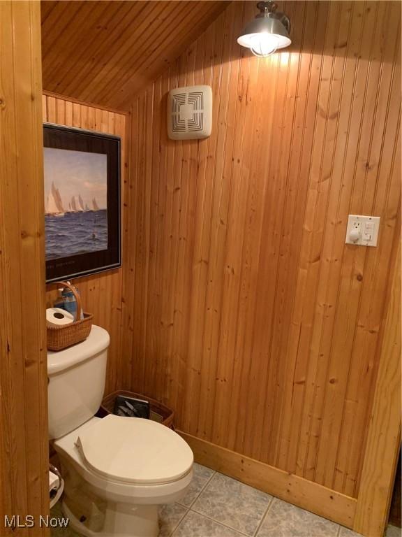 28815 State Route 7 N, Marietta, OH 45750 - bathroom with tile patterned floors, wooden walls, toilet, and lofted ceiling