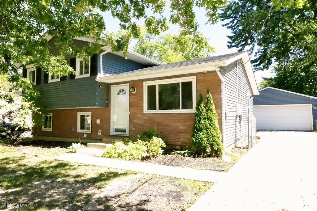 tri-level home with an outdoor structure and a garage