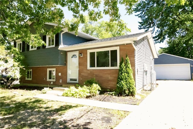 tri-level home with an outdoor structure and a garage