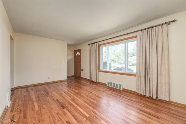 spare room with light hardwood / wood-style flooring