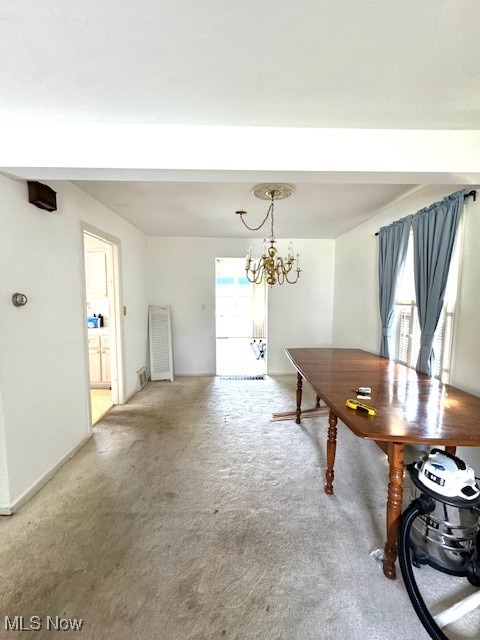 dining area with an inviting chandelier