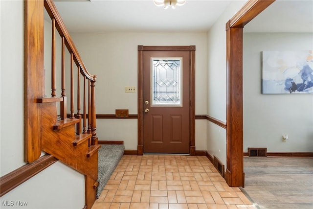 entryway featuring stairway, baseboards, and visible vents