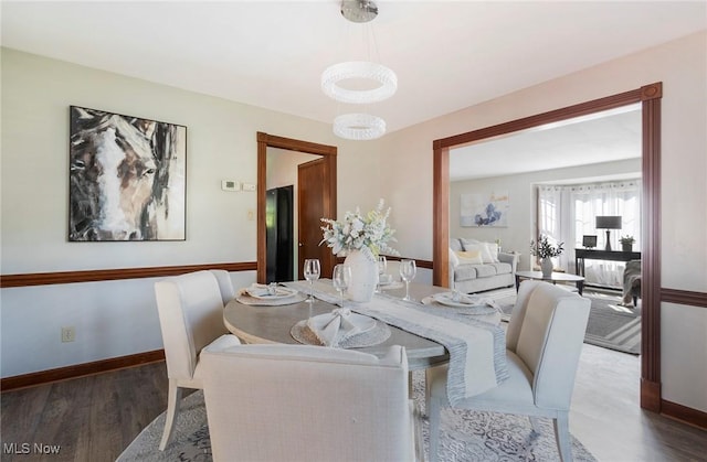 dining room with baseboards and wood finished floors