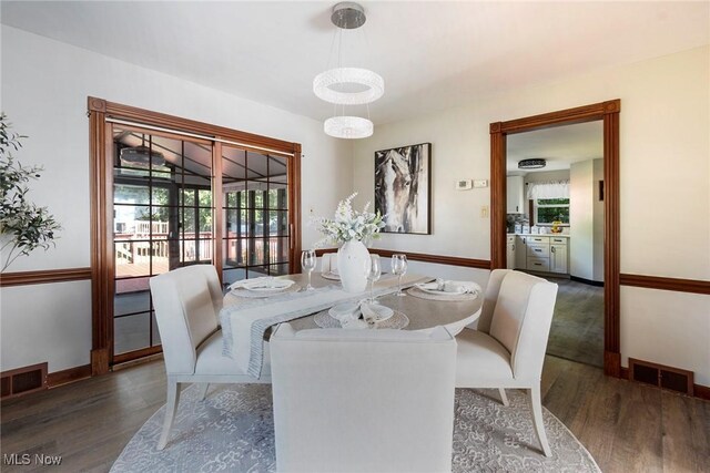 dining space with dark hardwood / wood-style floors and plenty of natural light