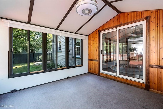 unfurnished sunroom featuring vaulted ceiling and plenty of natural light