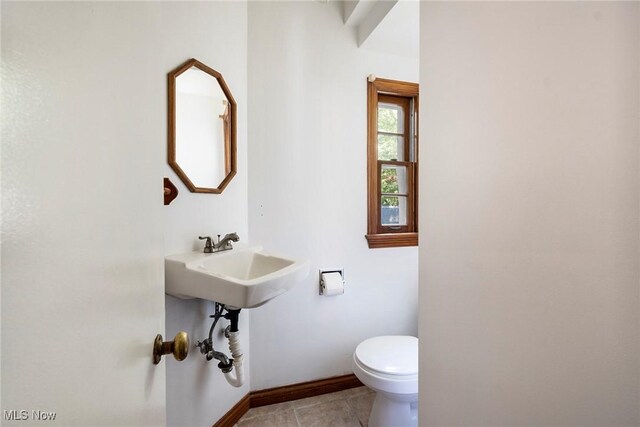 bathroom featuring tile patterned flooring, toilet, and sink