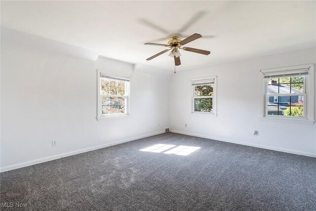 carpeted spare room with ceiling fan and a healthy amount of sunlight