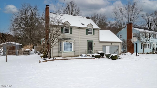 view of front of home featuring a garage and a chimney