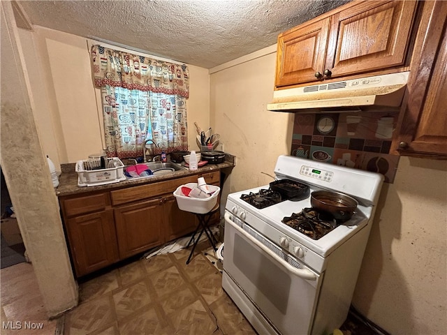 kitchen with sink, a textured ceiling, and white range with gas cooktop