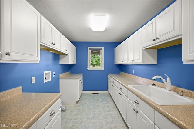 laundry area featuring hookup for a washing machine, cabinets, and sink