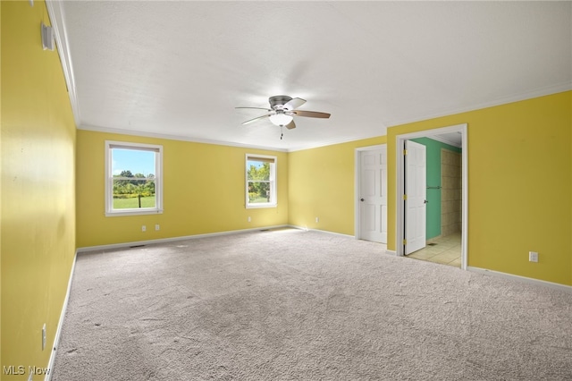 carpeted empty room with ceiling fan and ornamental molding