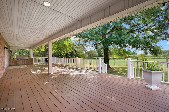 wooden deck with grilling area and a lawn