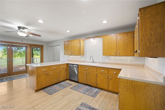 kitchen with light wood-type flooring, dishwasher, kitchen peninsula, sink, and ceiling fan