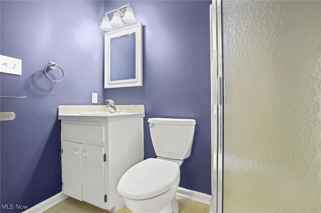 bathroom featuring vanity, toilet, and tile patterned floors