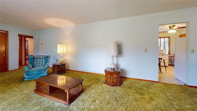 living room with ceiling fan and carpet