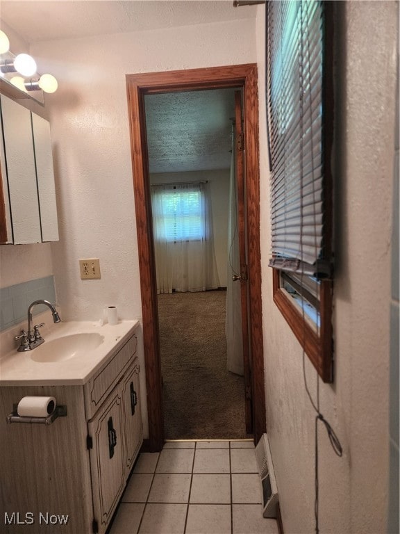 bathroom featuring tile patterned floors, a textured ceiling, and vanity