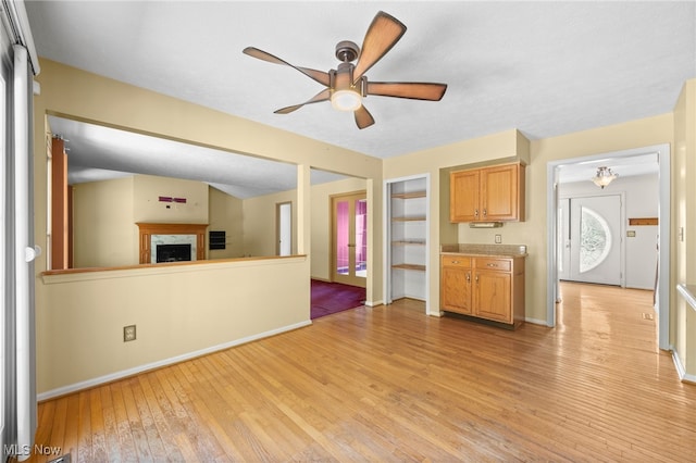 unfurnished living room featuring light hardwood / wood-style flooring and ceiling fan