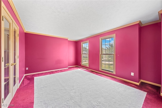 spare room featuring dark carpet, a textured ceiling, and ornamental molding