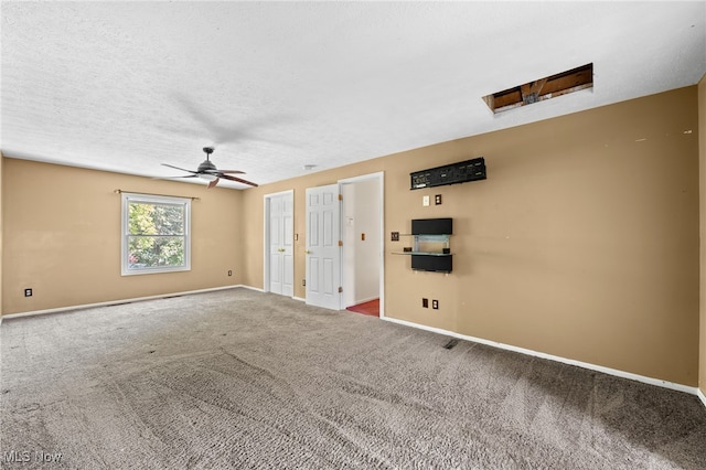 empty room featuring a textured ceiling, carpet flooring, and ceiling fan