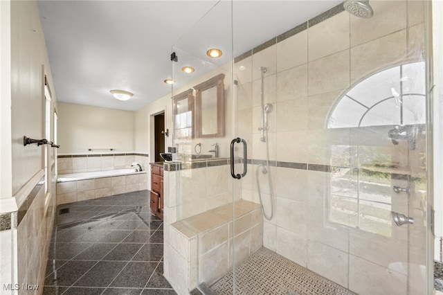 bathroom with vanity, shower with separate bathtub, and a healthy amount of sunlight