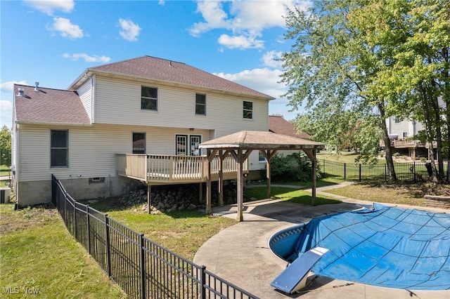 back of house featuring a lawn, a gazebo, a pool side deck, central AC, and a patio