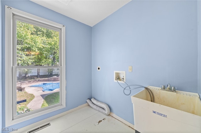 washroom featuring hookup for a washing machine, sink, electric dryer hookup, and a healthy amount of sunlight