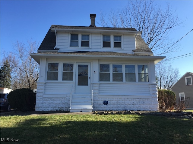 bungalow-style home featuring a front lawn