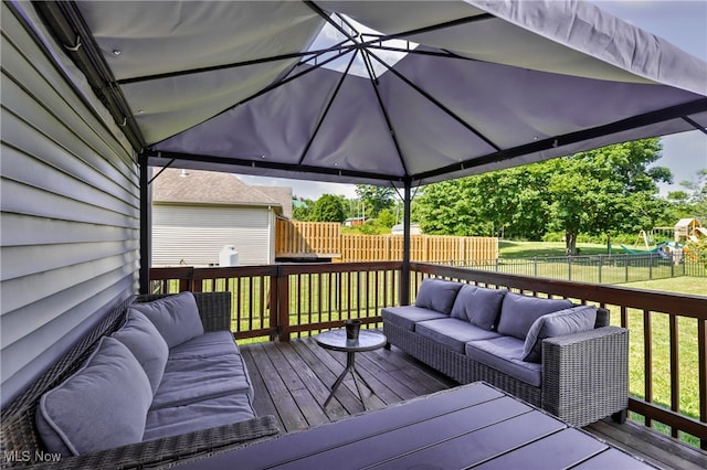 wooden deck with a lawn and outdoor lounge area