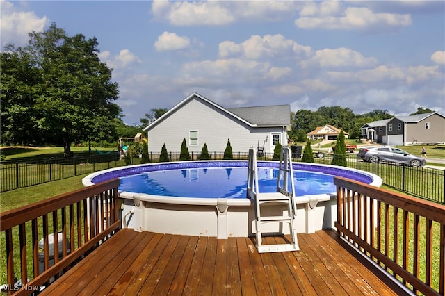 view of swimming pool with a lawn