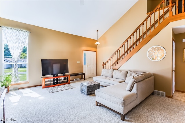 living room featuring high vaulted ceiling and carpet flooring