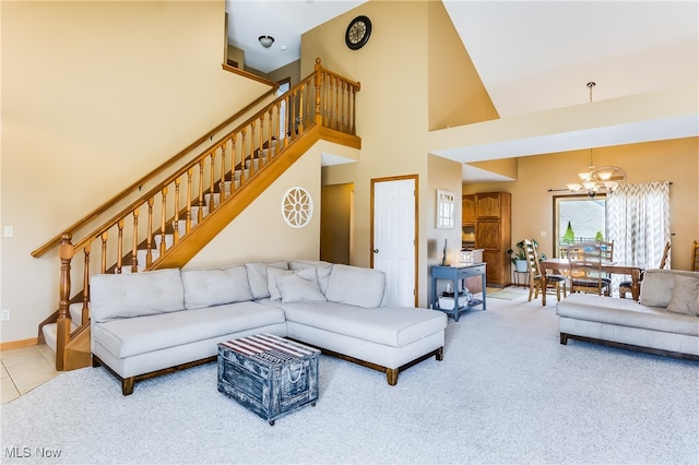 living room with a chandelier, a high ceiling, and carpet floors