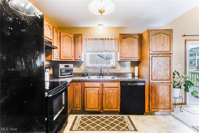 kitchen featuring a healthy amount of sunlight, black appliances, and sink