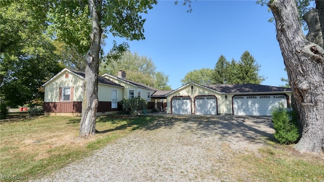 ranch-style house with a garage and a front yard