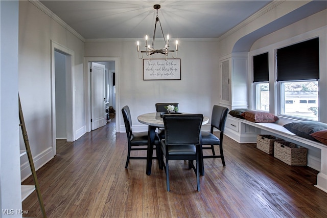 dining room featuring dark hardwood / wood-style floors, crown molding, and a notable chandelier