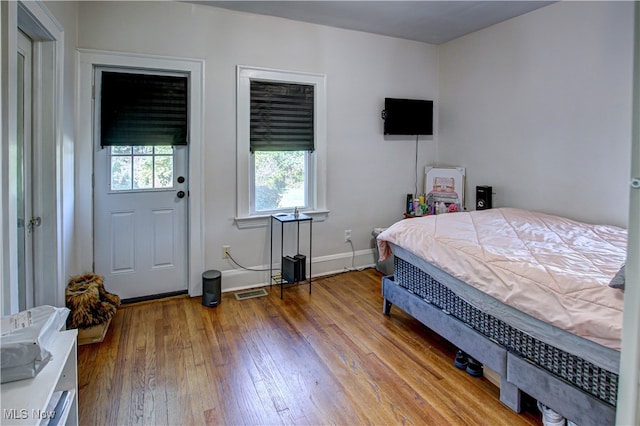 bedroom with hardwood / wood-style flooring