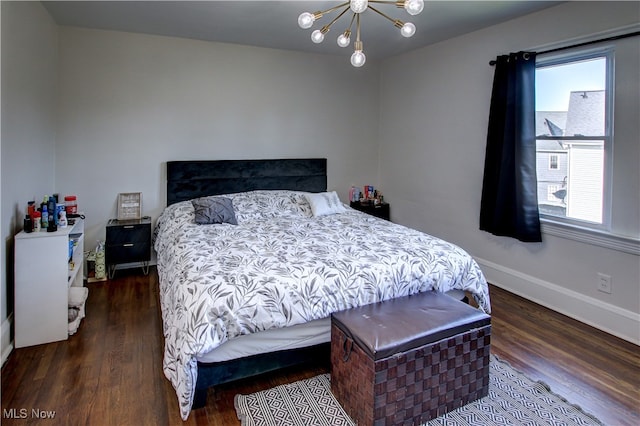 bedroom with dark wood-type flooring and a chandelier