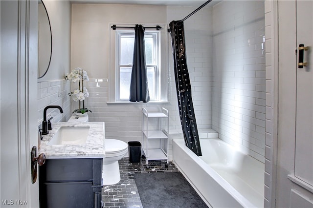 full bathroom featuring vanity, shower / tub combo with curtain, tile patterned flooring, tile walls, and toilet