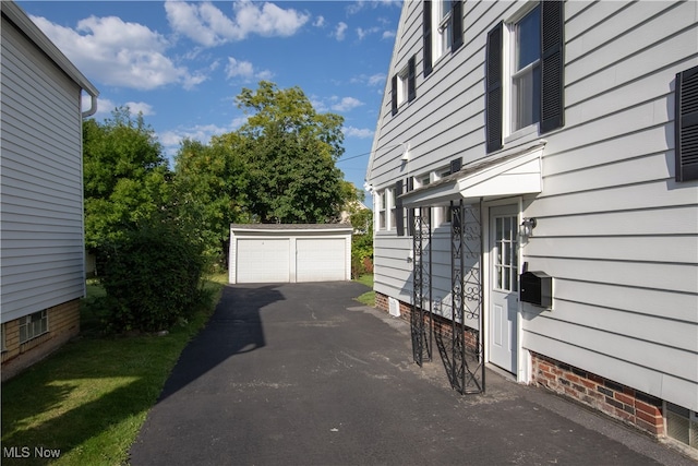 view of patio with an outdoor structure and a garage