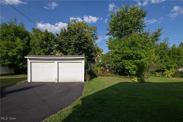 garage featuring a lawn