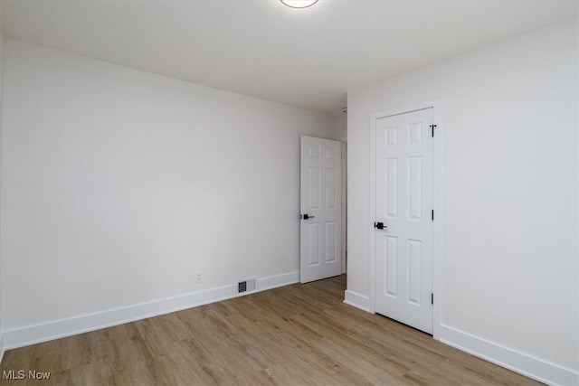 spare room with light wood-type flooring