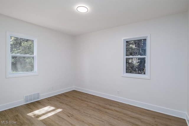 unfurnished room featuring hardwood / wood-style floors