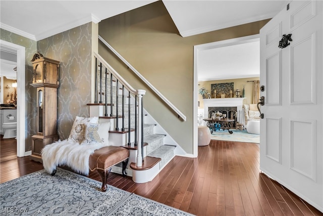 stairs featuring crown molding and hardwood / wood-style flooring