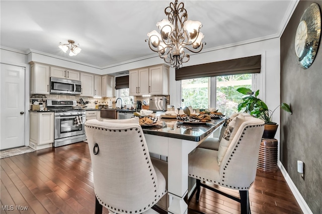 dining area with dark hardwood / wood-style floors, a chandelier, and crown molding