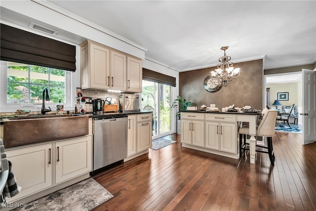 kitchen with dishwasher, a notable chandelier, sink, dark hardwood / wood-style floors, and cream cabinetry