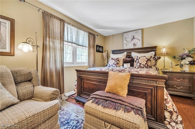 bedroom with dark wood-type flooring