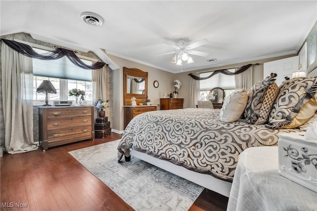 bedroom with ceiling fan, ornamental molding, and dark hardwood / wood-style flooring