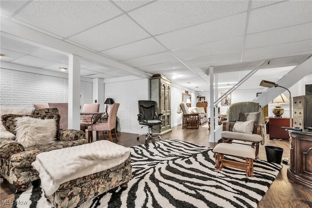 living room with a paneled ceiling and hardwood / wood-style floors